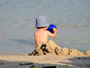 Child Digging in Beach Sand