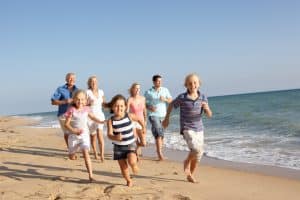 A family running on the beach