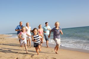 A family running together in the surf