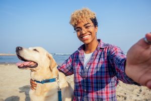 Woman with a dog on the beach