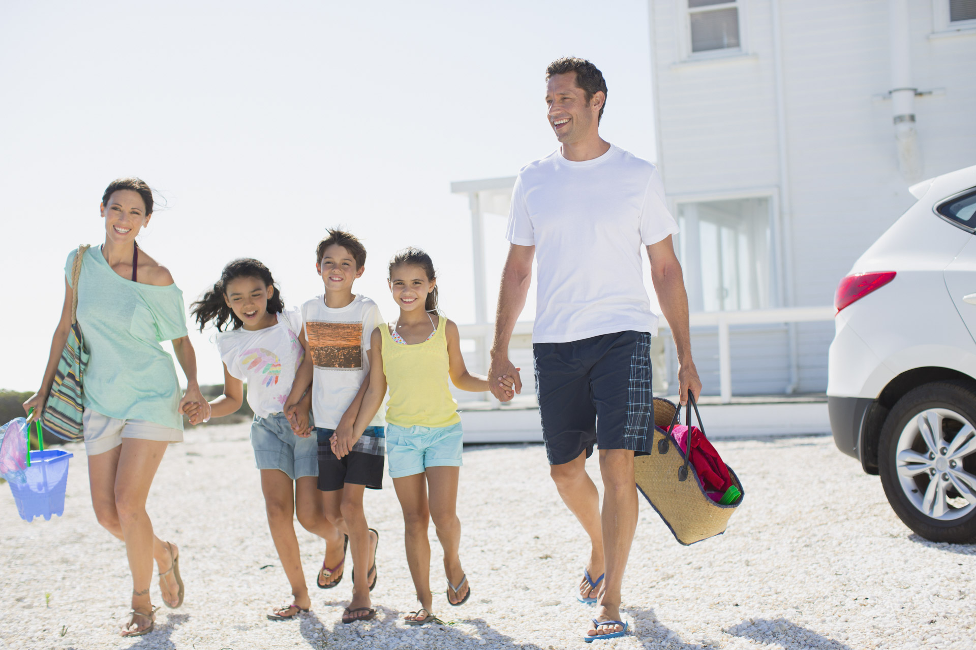 Family walking to beach from vacation rental