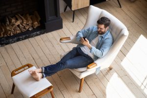 Man relaxing on vacation reading his phone