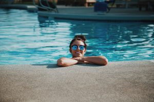 Woman resting on the edge of a swimming pool