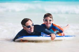 Father and son enjoying boogie boarding