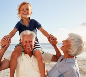 Grandparents Carrying Their Grandchild on the Beach