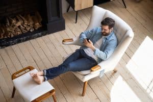 Man relaxing and reading from his device