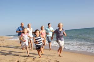 Happy family running on the beach